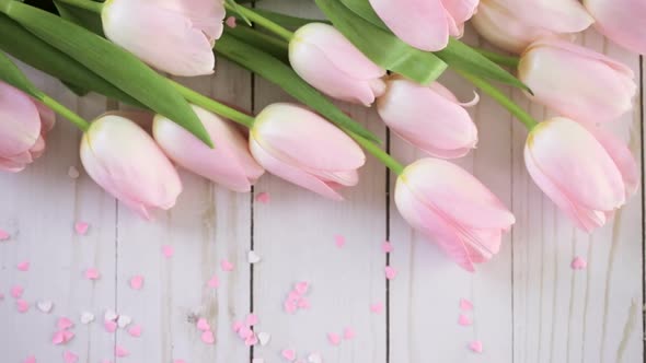 Bouquet of pink tulips on a wood background alt
