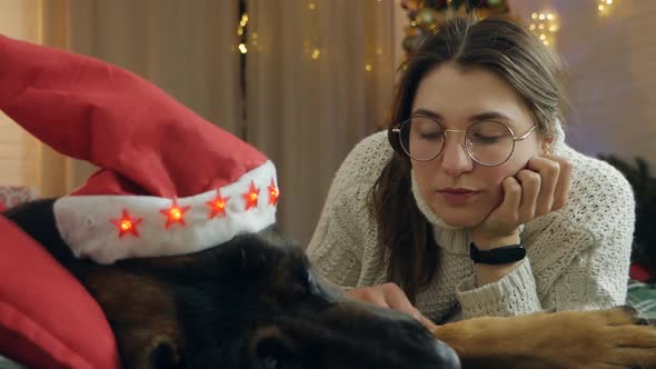 A Young Woman Celebrates Christmas and New Year at Home with Her Sick Dog