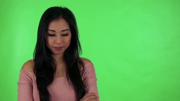 Young Attractive Asian Woman Agrees (Move with Head on Yes) - Green Screen Studio alt