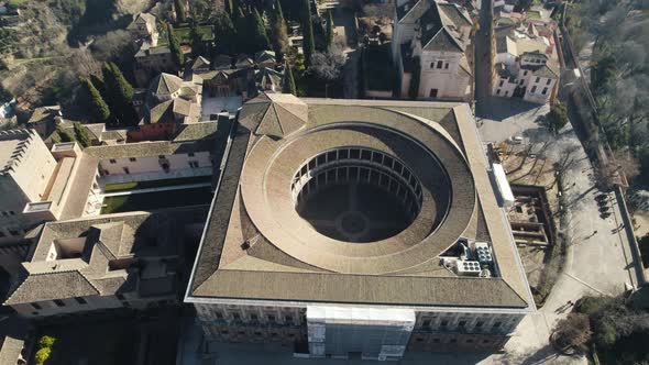 Aerial tilt down forward over Charles V Palace inside Alhambra citadel, Granada in Spain