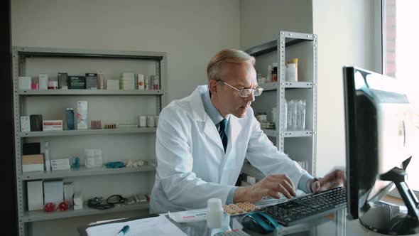 Timelapse Footage of Working Man Pharmacist Indoor of Drug Store alt