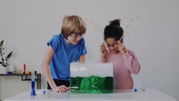 Excited and Expressive Multi Ethnic Kids Studying Chemistry in School. Glass Container with Boiling alt