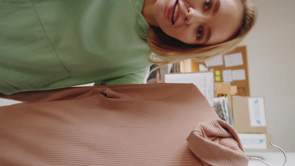 Young Cheerful Woman Discussing Clothes on Video Call alt