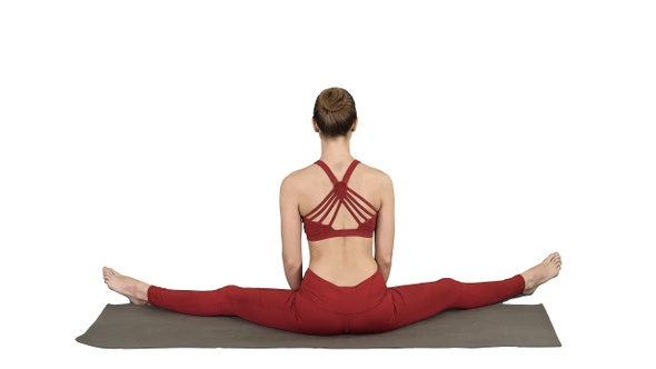 Woman taking a Lotus pose on white background. alt