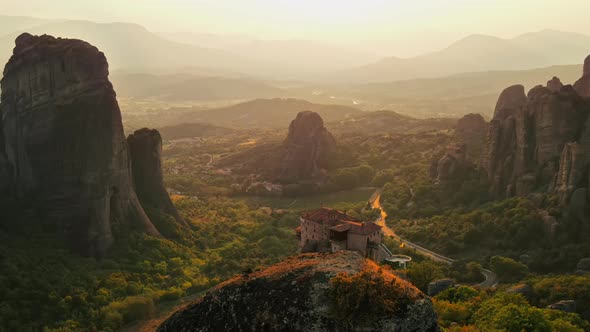 Aerial drone view of the Meteora in Greece at sunset. Rock formations with Orthodox monasteries alt