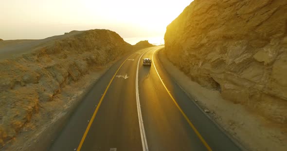 People Traveling by Car During Sunset on A Beautiful Road