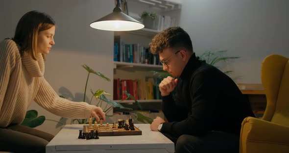 Young Friends Play Chess Game at Home