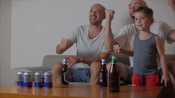 Fan Human Emotions and People Concept - Cheerful Young People Watching Sports on TV and Supporting alt