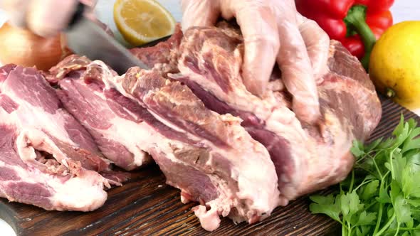 Chef Cut with Kitchen Knife Piece Pork Sirloin and Rubbing with Spices and Seasoning for Roasting alt