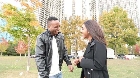 Happy black couple laughing at park