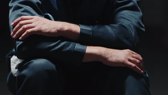 Closeup of Hands of Two Men Dressed in Prison Clothes