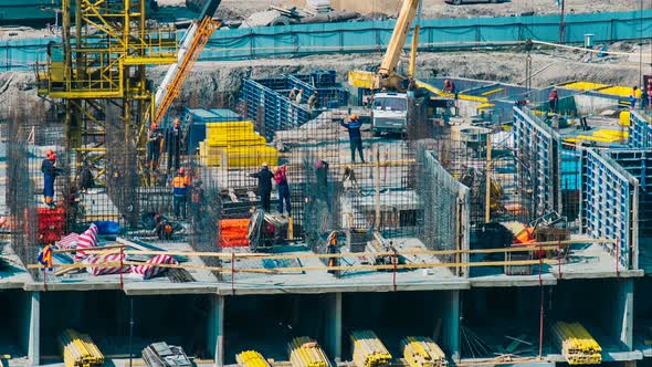 Professional Builders Work on Building Top Level with Cranes alt