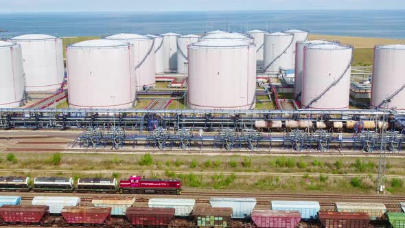 A Freight Train Is Moving By the Oil Refinery on the Seashore