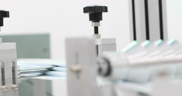 Production Of 3 Ply Disposable Surgical Mask On Mask Making Machine. - close up alt