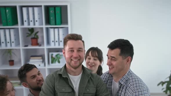 Team Building Happy Man Pallet Back Onto His Colleagues' Arms During Group Therapy Session alt