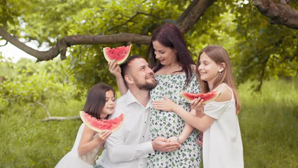 Positive Caucasian Family in Summer Clothes Posing Together at Green Garden and alt