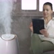 Woman with humidifier into dry air room. - VideoHive Item for Sale