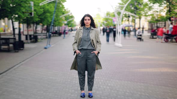 Time Lapse of Attractive Young Woman Standing in City Center on Busy Street alt