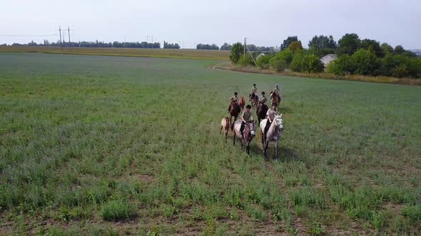 Group Of Horseback Riders. Group of young horseback riders riding in countryside alt