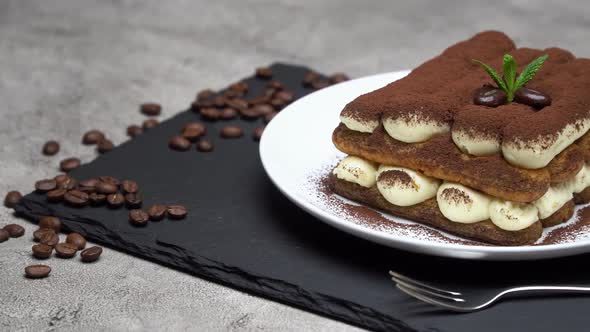 Classic Tiramisu Dessert on Ceramic Plate on Concrete Background alt