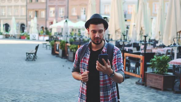 Tourist Making Video Call on Smartphone and Showing His Place of Visit alt