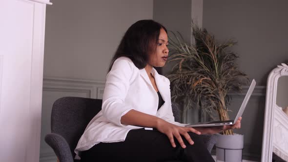 Smiling African American Business Woman Use Laptop Talk on Video Call with Partner or Client