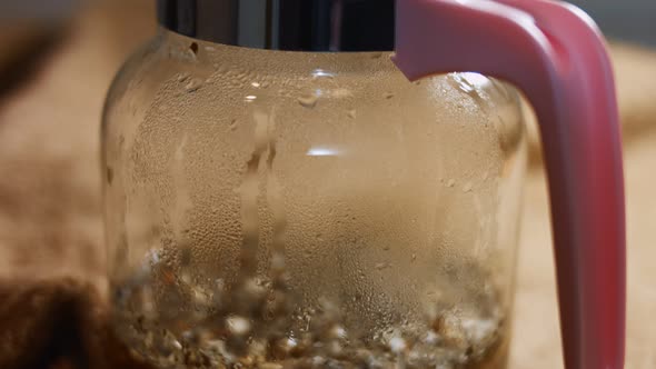Closeup View of Aromatic and Relaxing Infusion of Tea From Sri Lanka in a Transparent Teapot alt