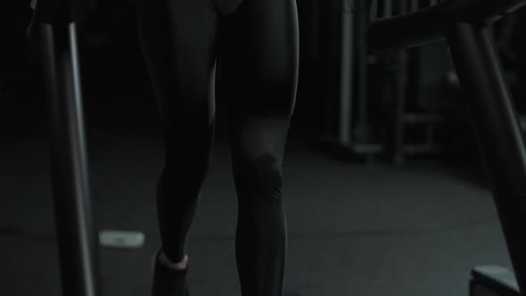 Ypung Female Athlete Run on a Treadmill Aerobic Exercise and Endurance Training in the Gym Slow alt