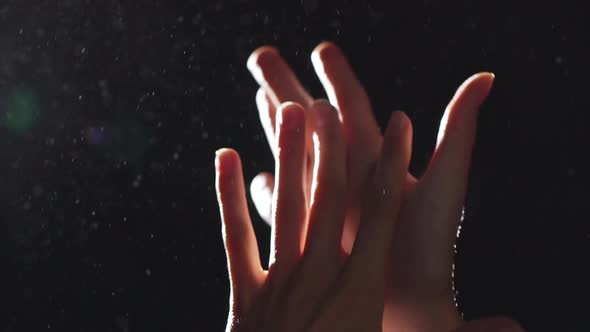 Silhouette Portrait of Two Elegant Female Arms Closeup Rubbing Hands and Playing in Light with alt