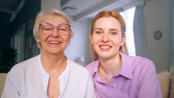 Mother and daughter doing video chat for distance communication at home alt