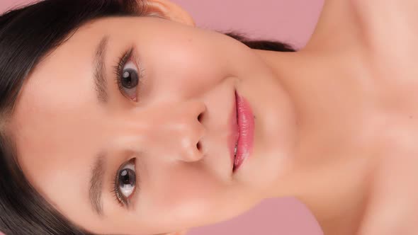Beautiful Young Asian Woman Looking At Camera On Vertical Screen. alt