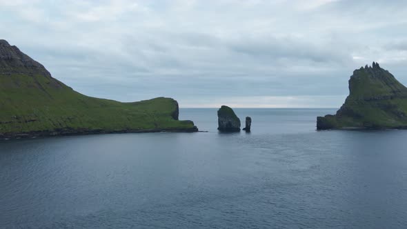 Drone Towards Drangarnir Sea Stacks In Faroe Islands alt