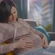 a Pregnant Woman is Sitting on the Couch and Experiencing Discomfort - VideoHive Item for Sale