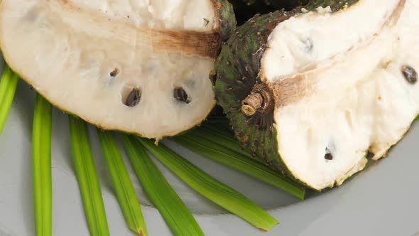 Closeup of Green Soursop Graviola, Exotic, Tropical Fruit Guanabana on Plate alt