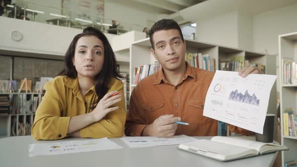 Two Colleagues s Talking By Video Call Showing Infographic Statistics Mixed Race alt