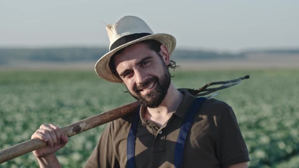 Portrait of Smiling Farmer with Pitchfork alt