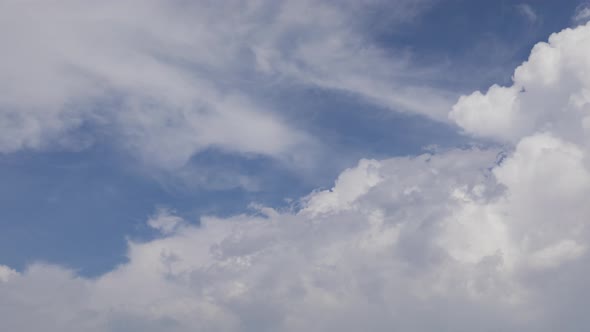 Epic day time lapse of big and dramatic puffy tropical clouds and blue sky alt