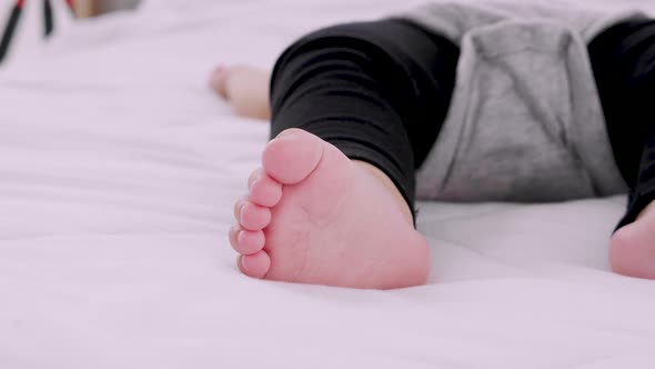 Close-up portrait of baby feet and a sleeping newborn baby, Slow motion