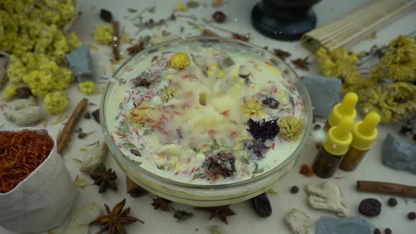 Woman's hand puts ingredients to the glassware for preparation domestic cosmetics 