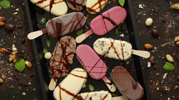 Set of Delicious White and Milk Chocolate and Strawberry Ice Cream on a Stick Served in Metal Tray alt