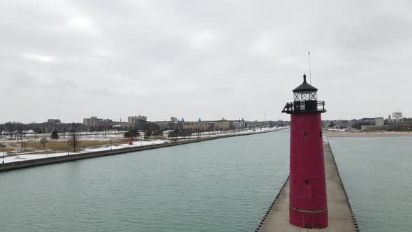 Aerial view of lighthouse and long pier in Wisconsin in winter.