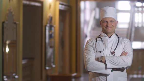 Confident doctor looking at the camera and smiling.. alt