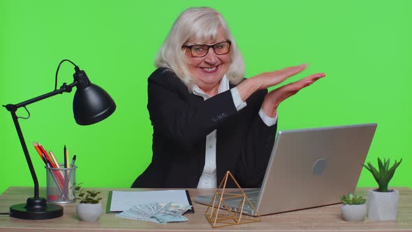 Senior Rich Businesswoman Showing Wasting or Throwing Money Around Hand Gesture More Tips Cashback alt