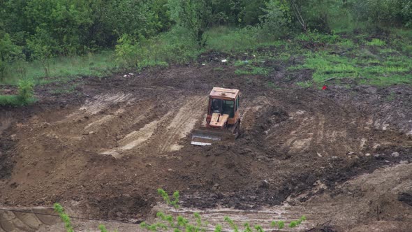 Timelapse: bulldozer flattening surface on further construction site. 4K