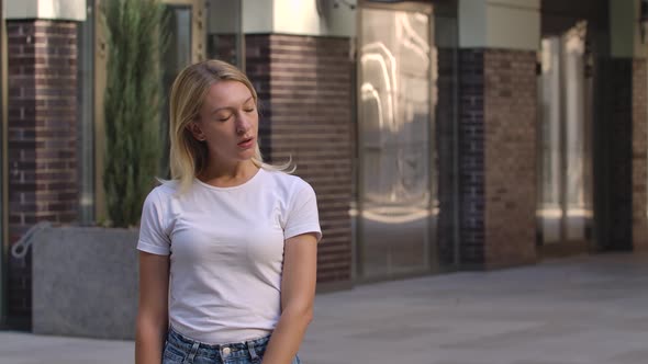 Portrait of Pretty Young Woman Removes a Protective Medical Mask From the Face and Breathes Fresh alt