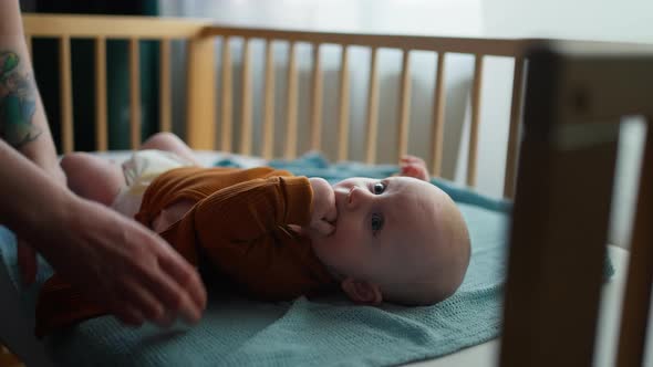 Mom Changing Baby Diaper alt