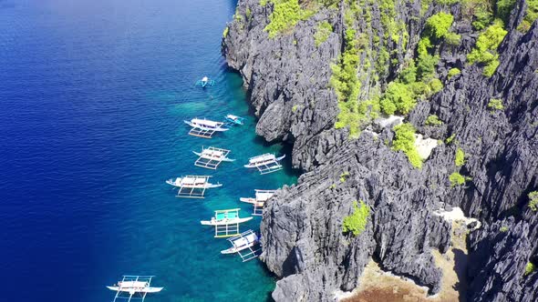 Aerial Drone View of Swimmers Inside a Tiny Hidden Tropical Lagoon Surrounded By Cliffs - Secret alt