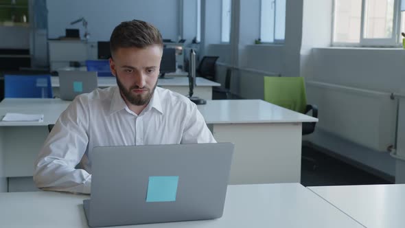 Close Up View of Concentrated Man That Sits at the Computer alt