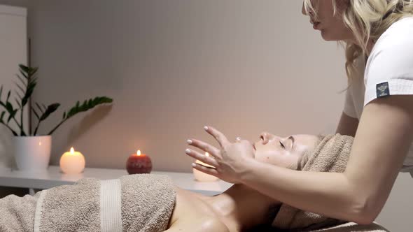 Relaxing massage. Woman receiving head massage at spa salon, side view alt