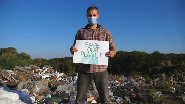 Young Man in Medical Protective Mask Looking Into Camera and Standing Against the Background of alt